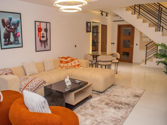 a living room with a couch and a table at Pwj Realty Apartments in Lekki