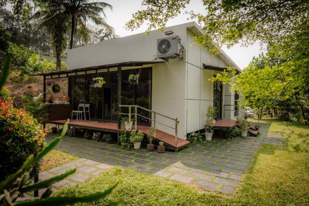 a house with glass doors and a patio at Ginger Villa Farmstay, Thodupuzha in Idukki