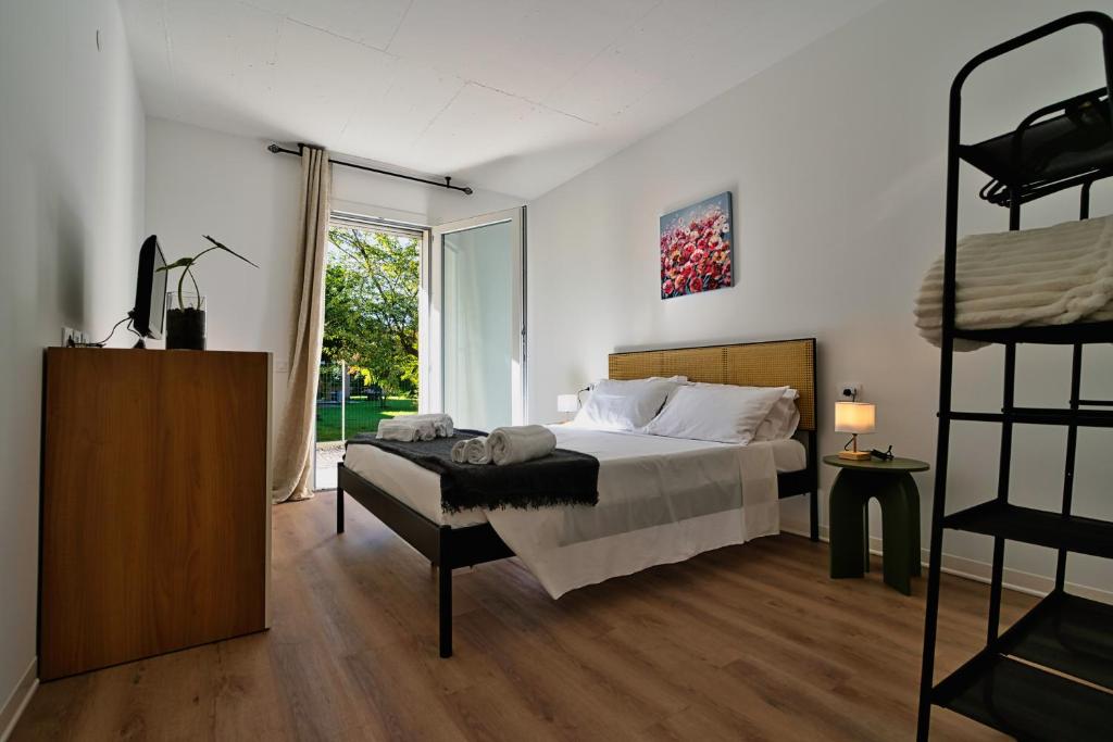 a bedroom with a bed and a bunk bed at Il Papavero, raffinato, accogliente, lussuoso appartamento in Santo Stino di Livenza