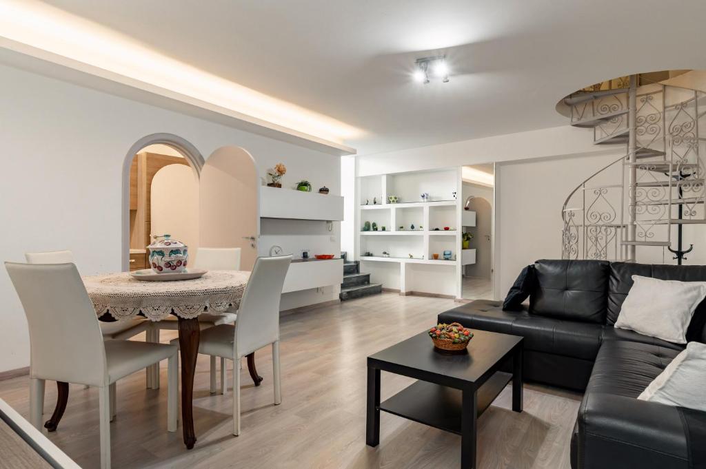 a living room with a table and a couch at Domus Elisae - Taormina in Taormina