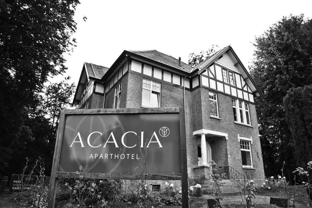 a building with a sign in front of it at Aparthotel Acacia in Eeklo