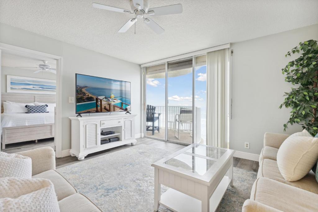 a living room with a couch and a tv at Ocean Walk 506 in Indian Harbour Beach