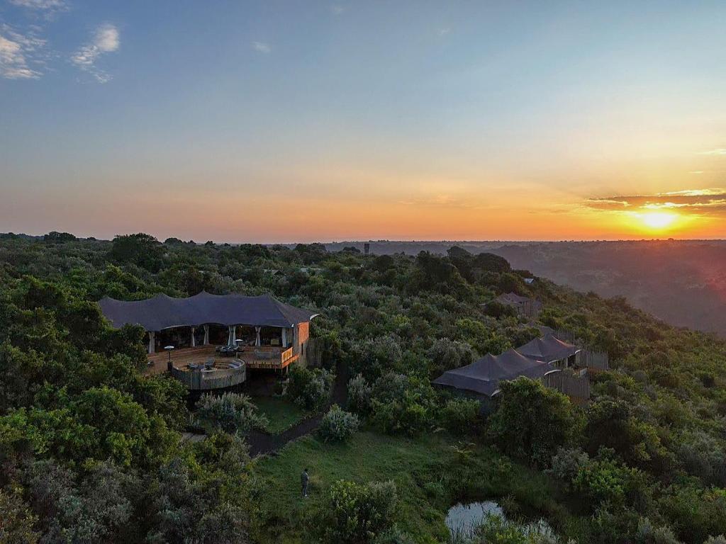 an aerial view of a house in the forest at sunset at Pearl Mara in Masai Mara