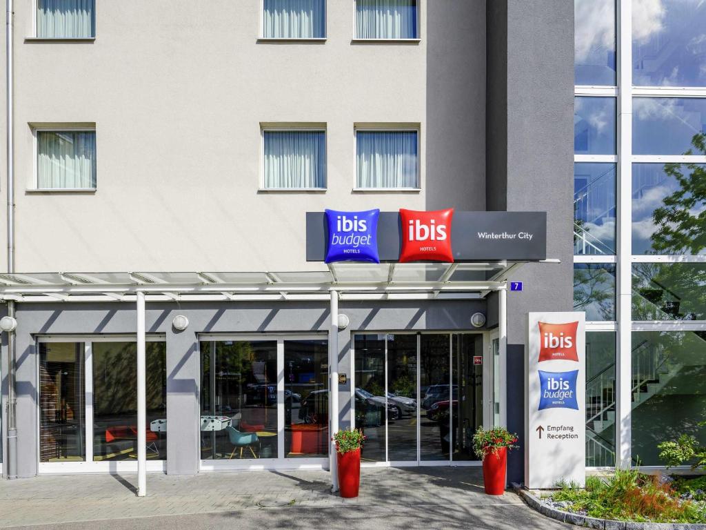 a building with the front of autsche bosch store at ibis budget Winterthur in Winterthur