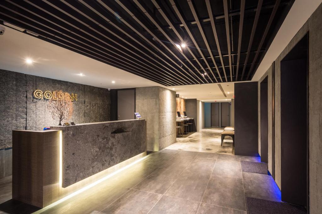 a lobby with a reception desk in a building at Goldinn Hotel in Taipei