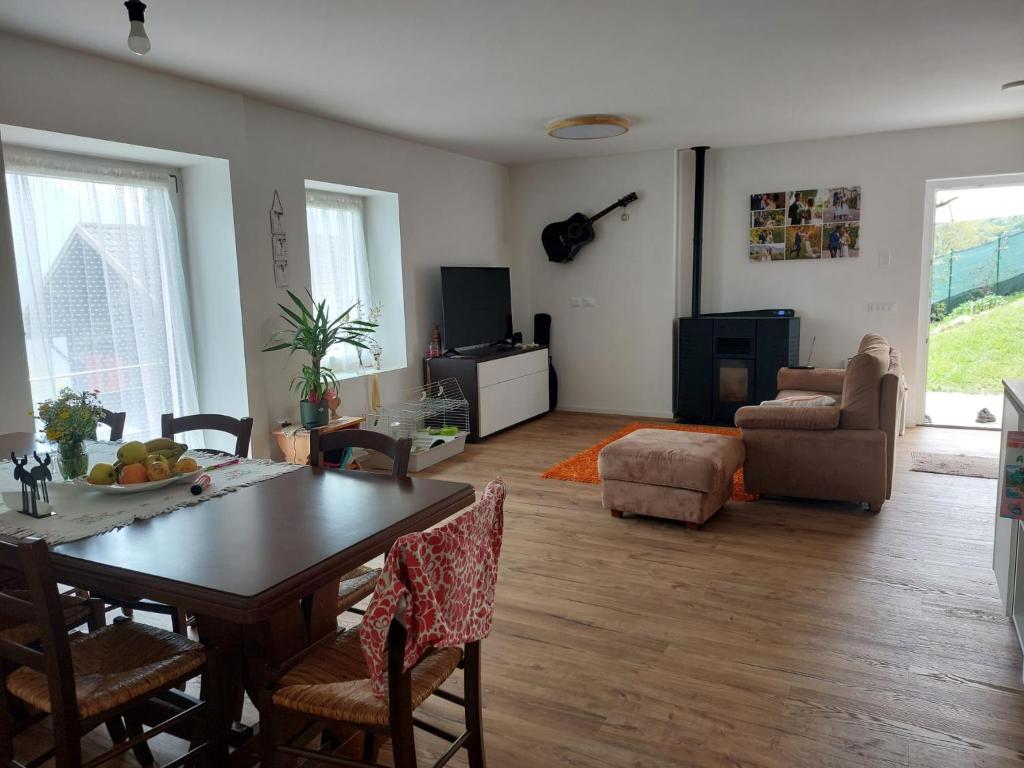 a living room with a table and chairs and a couch at Gemma del Lagorai in Torcegno