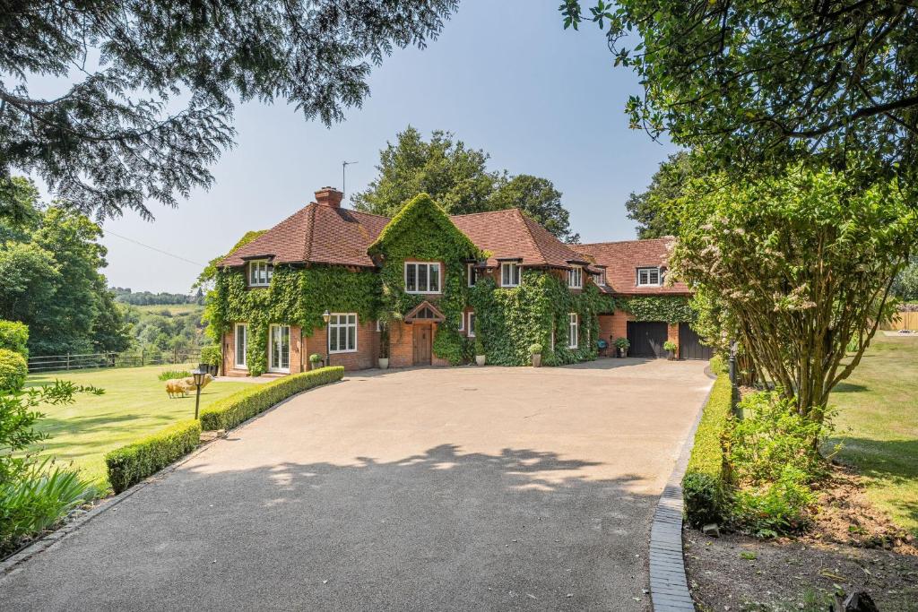 a large house with a driveway in front of it at Old Lakenham by Group Retreats in Boughton Monchelsea