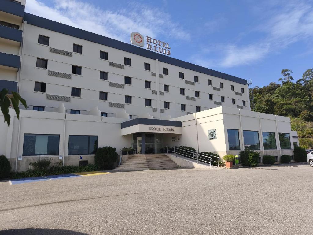 a hotel building with a car parked in front of it at Hotel D. Luis in Coimbra