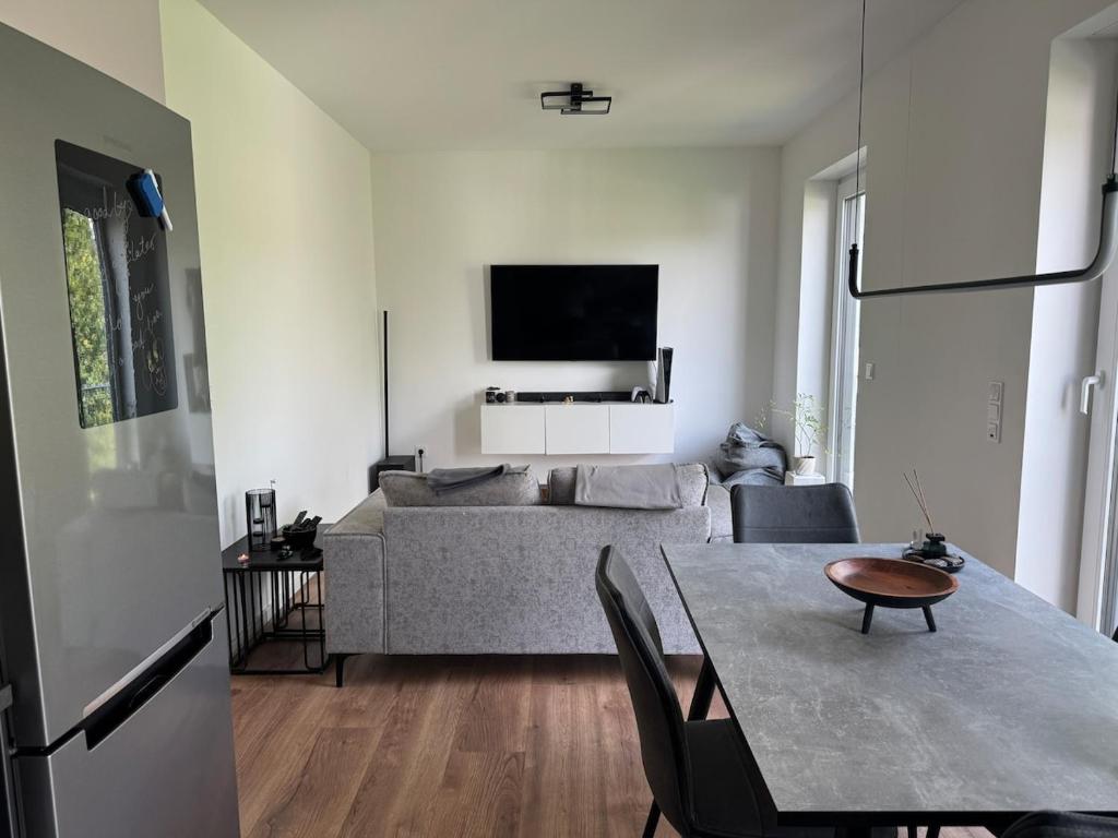 a living room with a couch and a table at Beautiful 3-room apartment in Lohmar in Lohmar