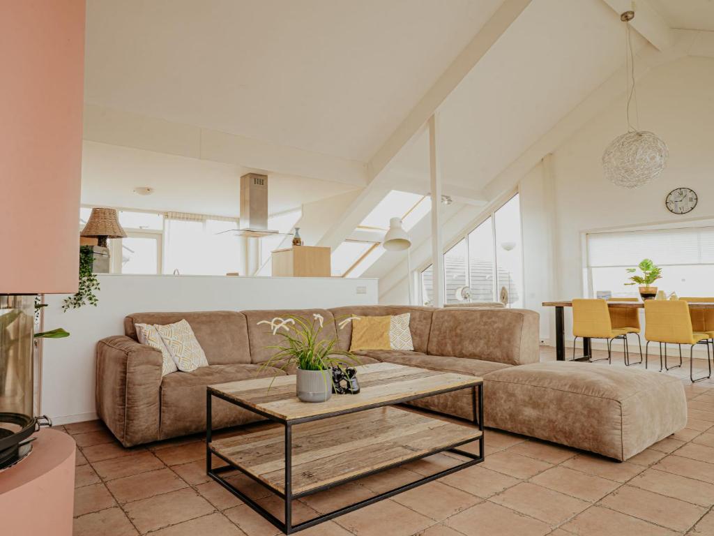 a living room with a couch and a table at Apartment Penthouse by Interhome in Uitgeest