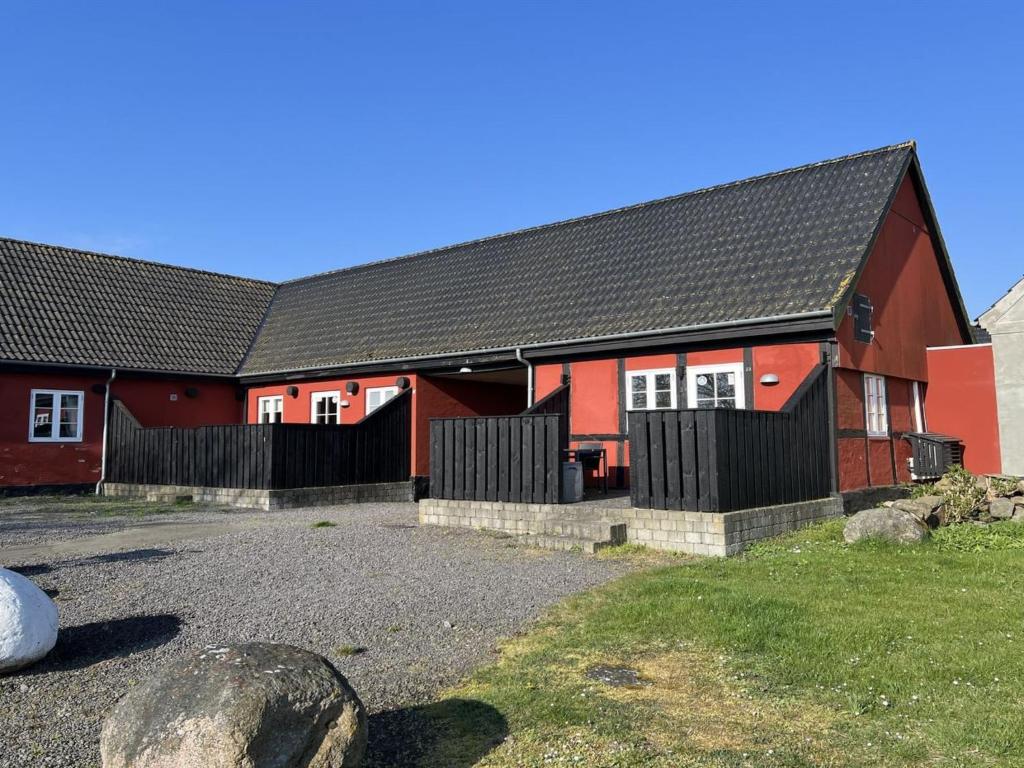 a red house with a black roof at Apartment Lutz - 6km from the sea by Interhome in Åkirkeby