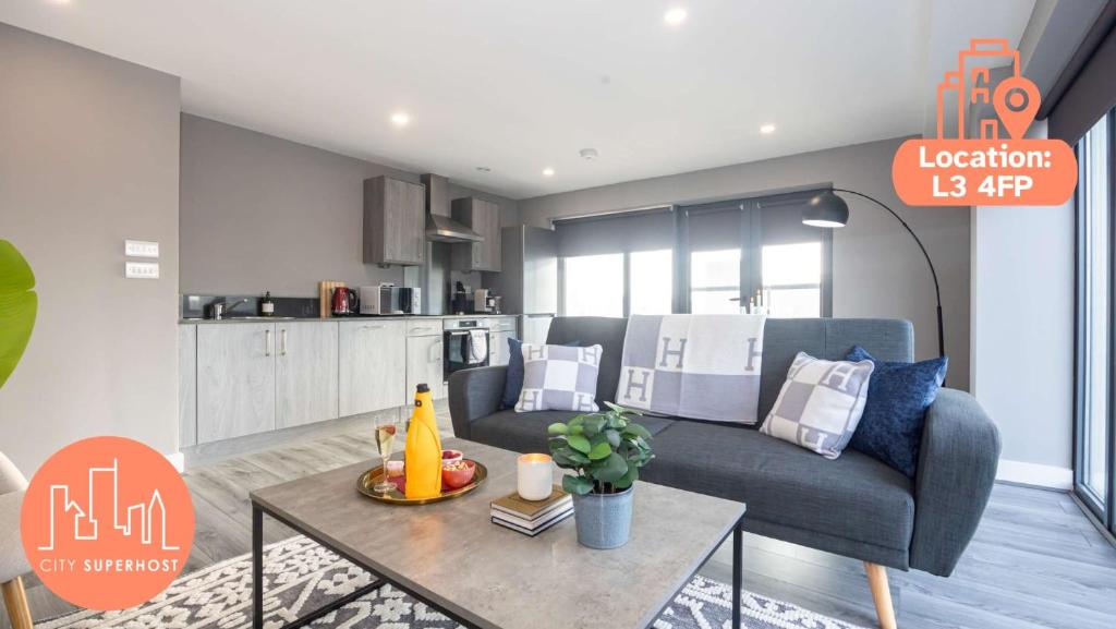 a living room with a couch and a table at Stunning Liverpool Dockside Apt by City SuperHost in Liverpool