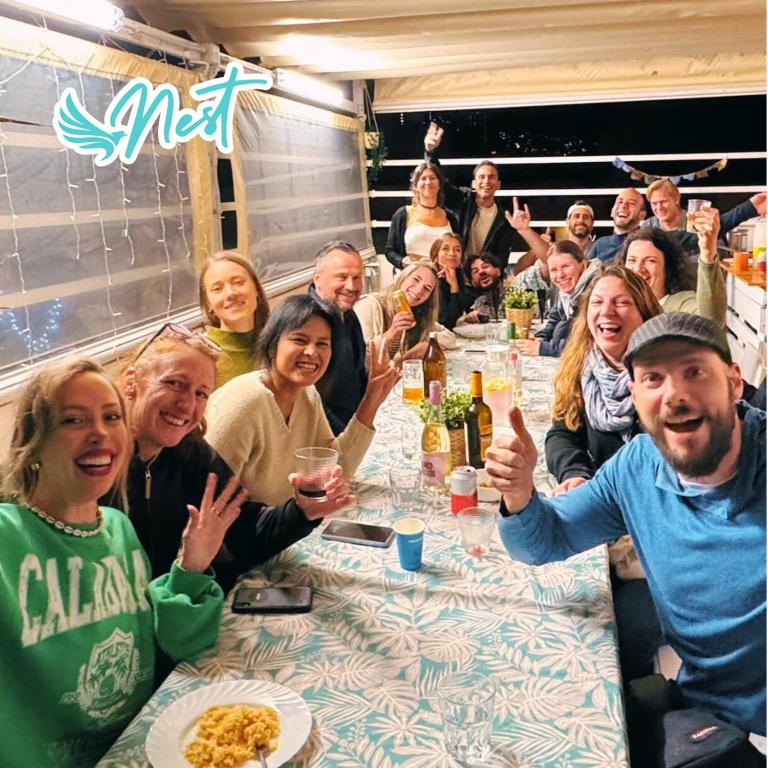 a group of people sitting at a dinner table at Puerto Nest Hostel in Puerto de la Cruz