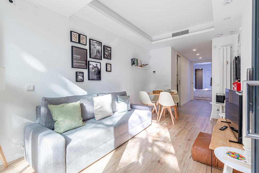 a living room with a couch and a table at Residencias Bernabéu in Madrid