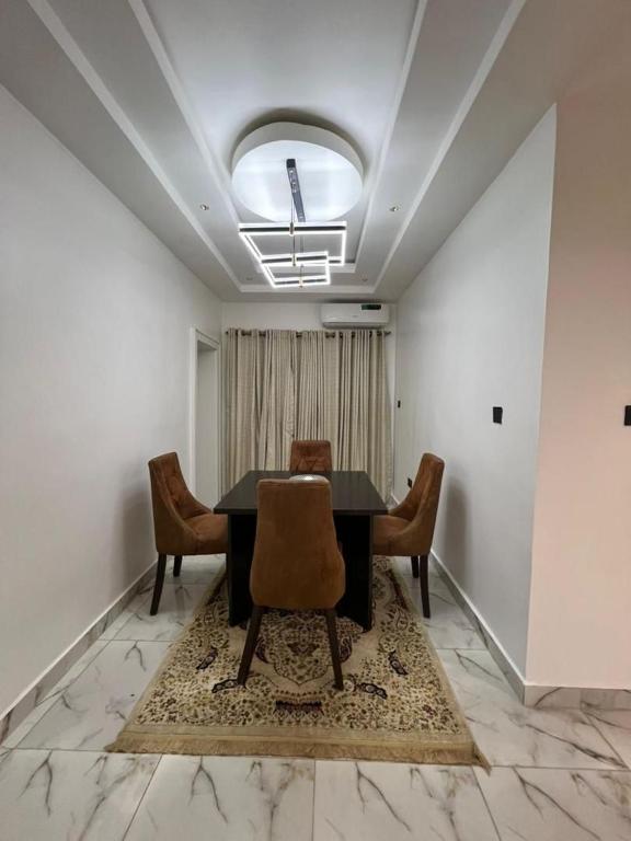 a dining room with a table and chairs at Diligent Homes in Abuja