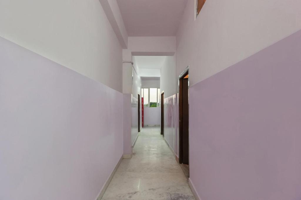an empty corridor with white walls and a hallway at Hotel O New Banjara Residency in Hyderabad