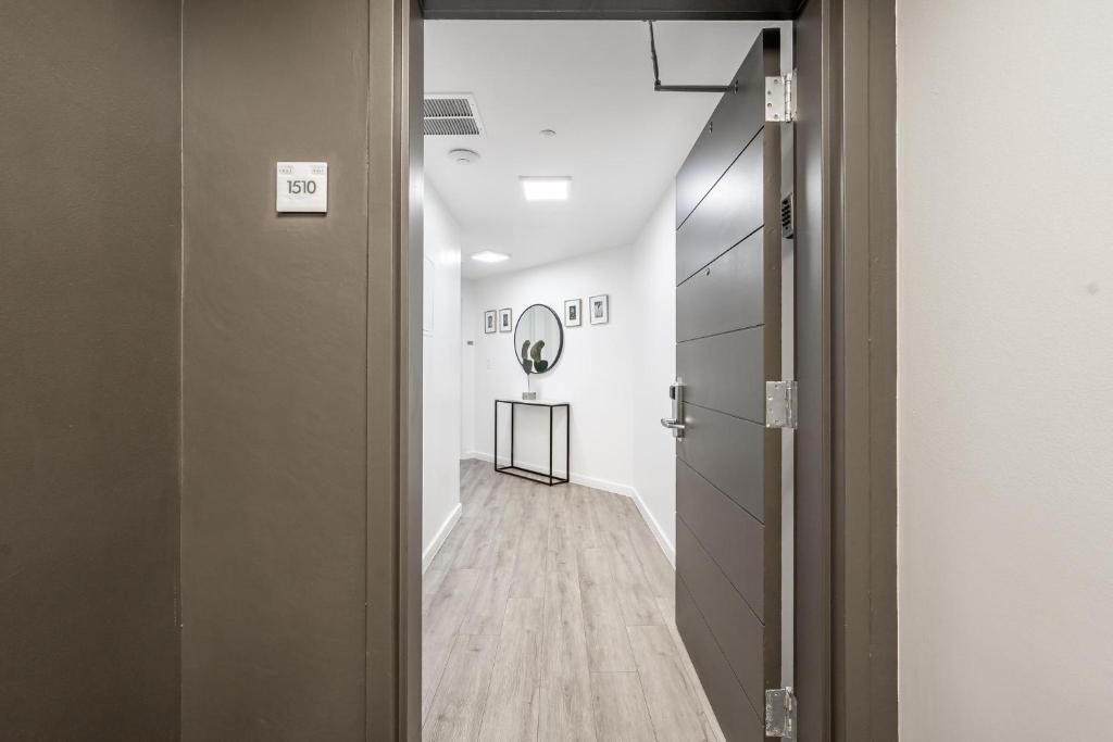 a room with a hallway with a mirror on the wall at Spacious Connecting Studios Sleeps 4 with 2 Parking Spots in Miami