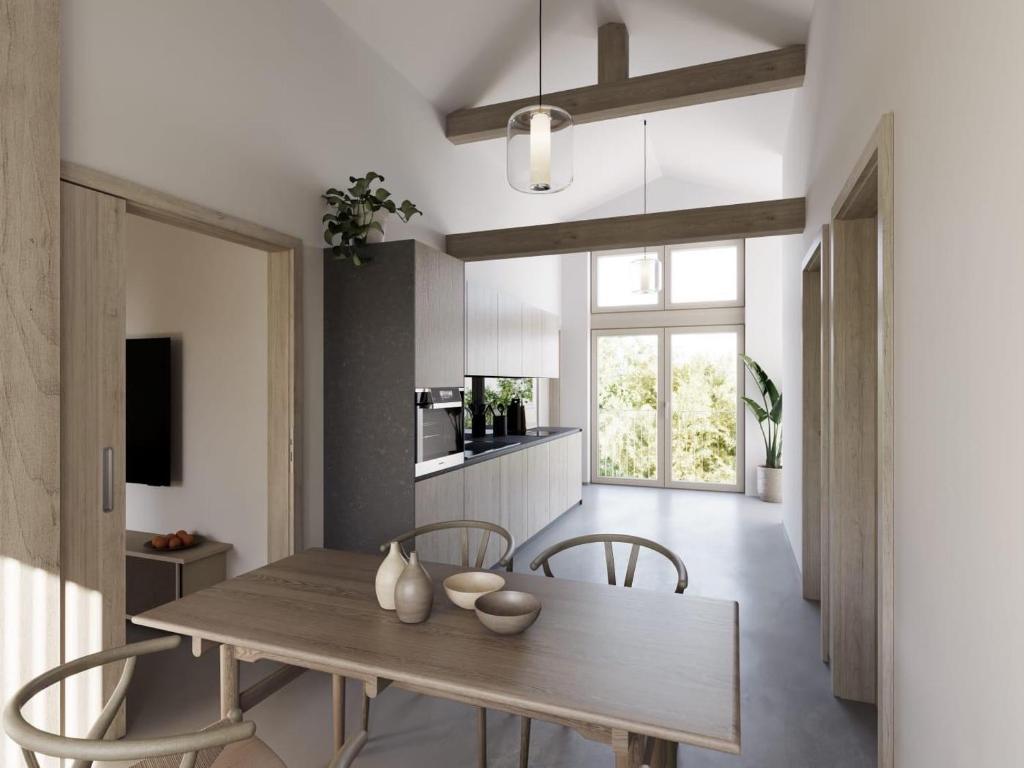 a kitchen and dining room with a wooden table and chairs at Appartements No37 in Hüttschlag