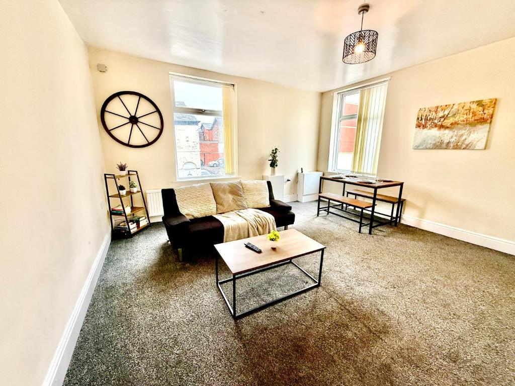a living room with a couch and a table at Comfy Entire Apartment with Free Parking in Bury Town in Bury