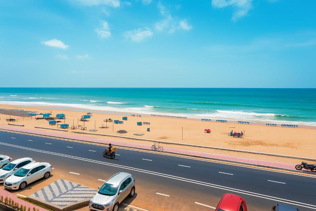 a highway with cars parked next to a beach at Rooftop Sea View Boutique Shivangi Hotel Near Jagannath Temple 1400m - Restaurant- Lift and Free Parking Facilities - Fully Air Conditioning Premium Rooms- Best Sea Beach Hotel In Puri in Puri