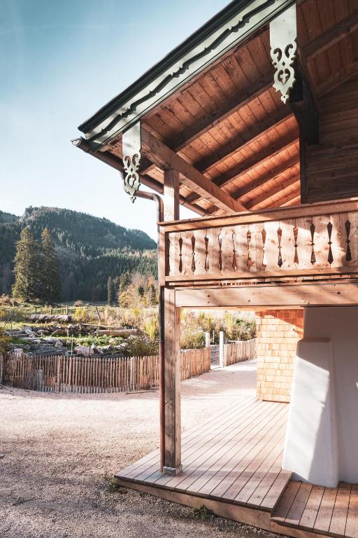 a wooden pergola on a patio of a house at STUBN in der Frasdorfer Hütte in Frasdorf