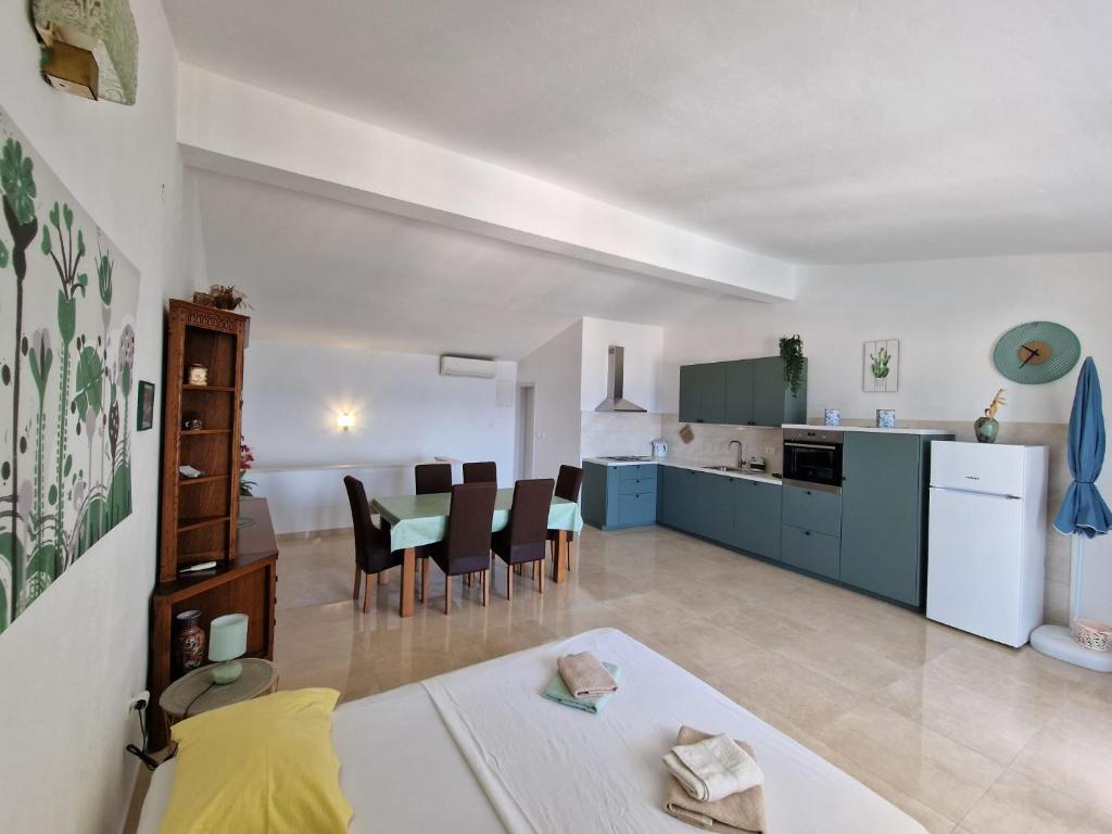a kitchen and living room with a table and chairs at Jurlinka in Živogošće