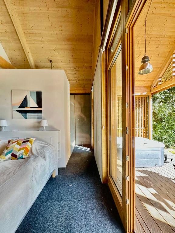 a bedroom of a house with a bed and a porch at Soling apartmanház Velence in Velence