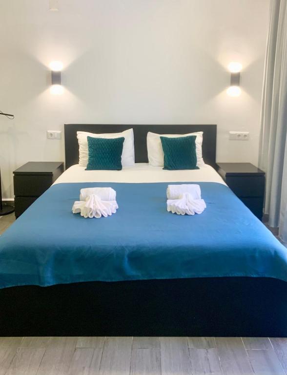 a large blue bed with two towels on it at Almada Downtown 103 in Porto