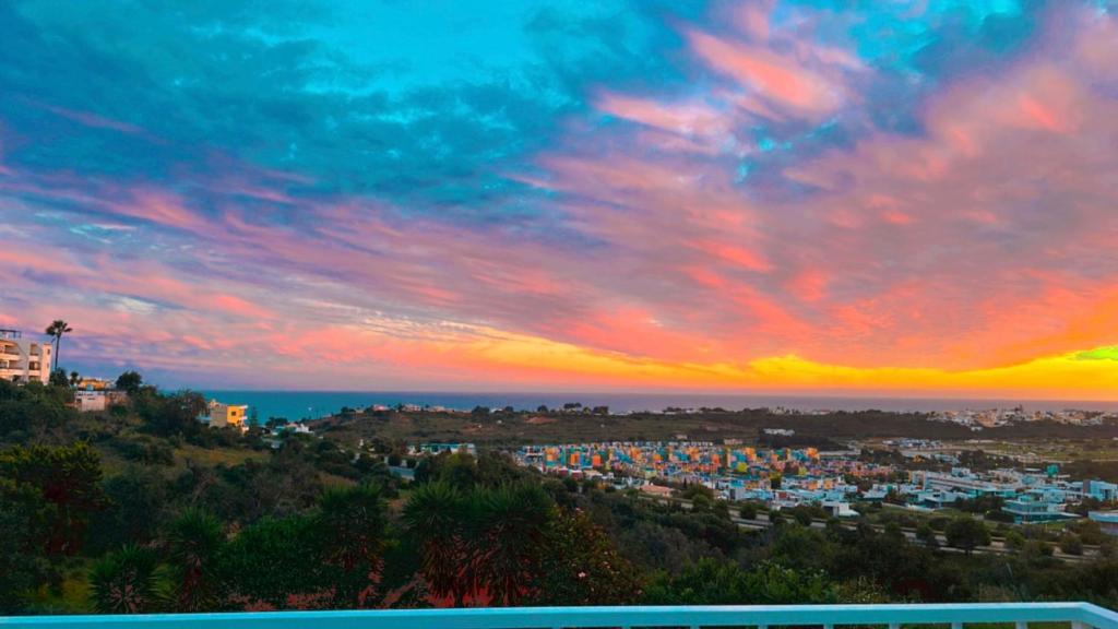 a view of a city with a sunset at Ocean View Skyline Apartment ‚Hakuna Matata‘ in Albufeira