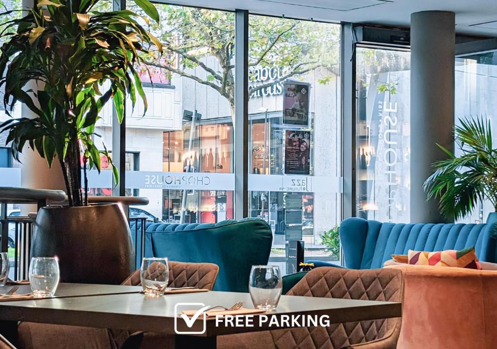 a cafe with a table and chairs and a large window at Future Inn Bristol in Bristol