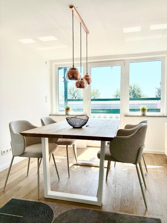 a dining room with a table and chairs at Lake view, central, terrace in Niederdorla