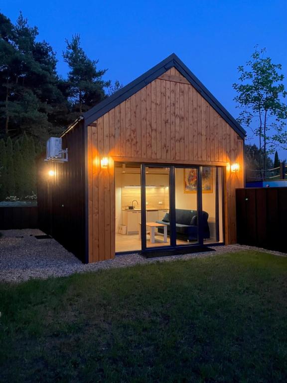 a small house with a large glass door at domkibajka 