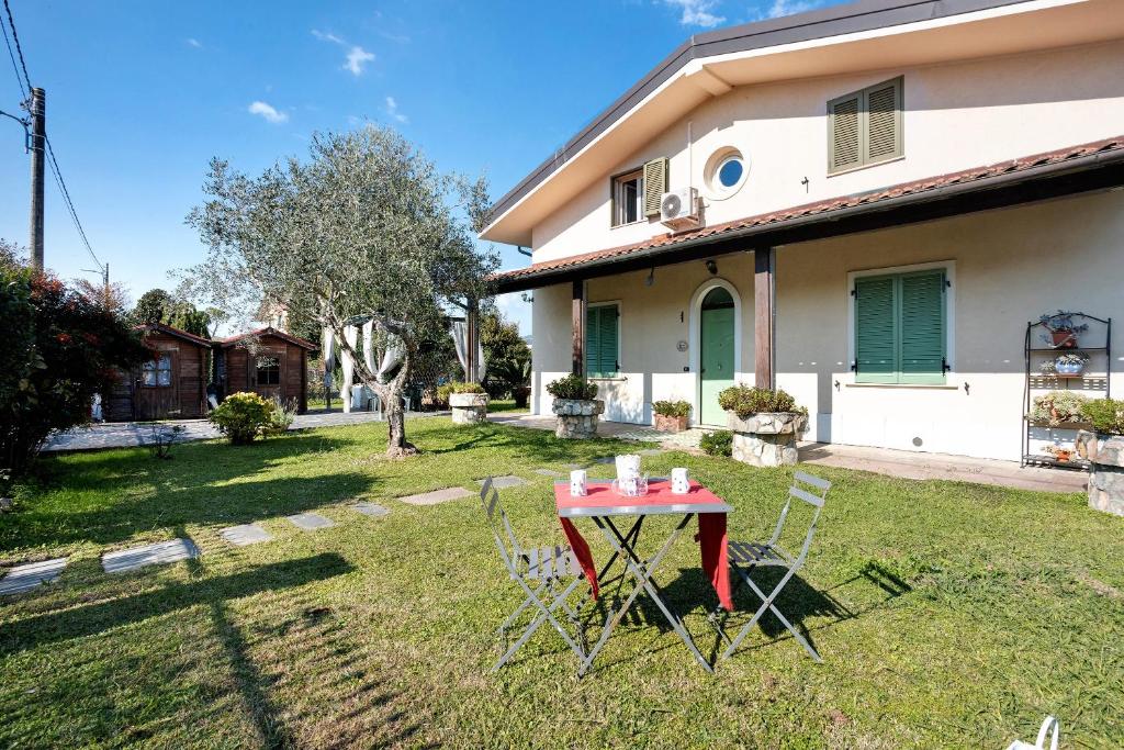 - une table et des chaises dans la cour d'une maison dans l'établissement Il Verziere Delle Rose, à Massa