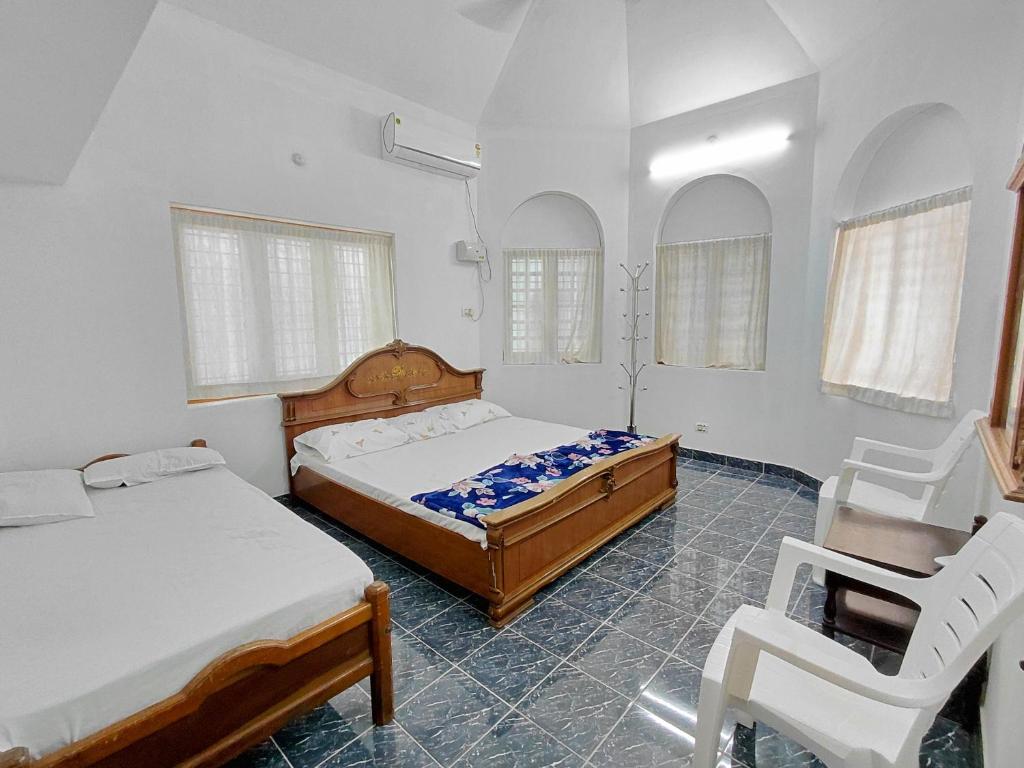 Postel nebo postele na pokoji v ubytování Guruvayur Agraharam Homestay