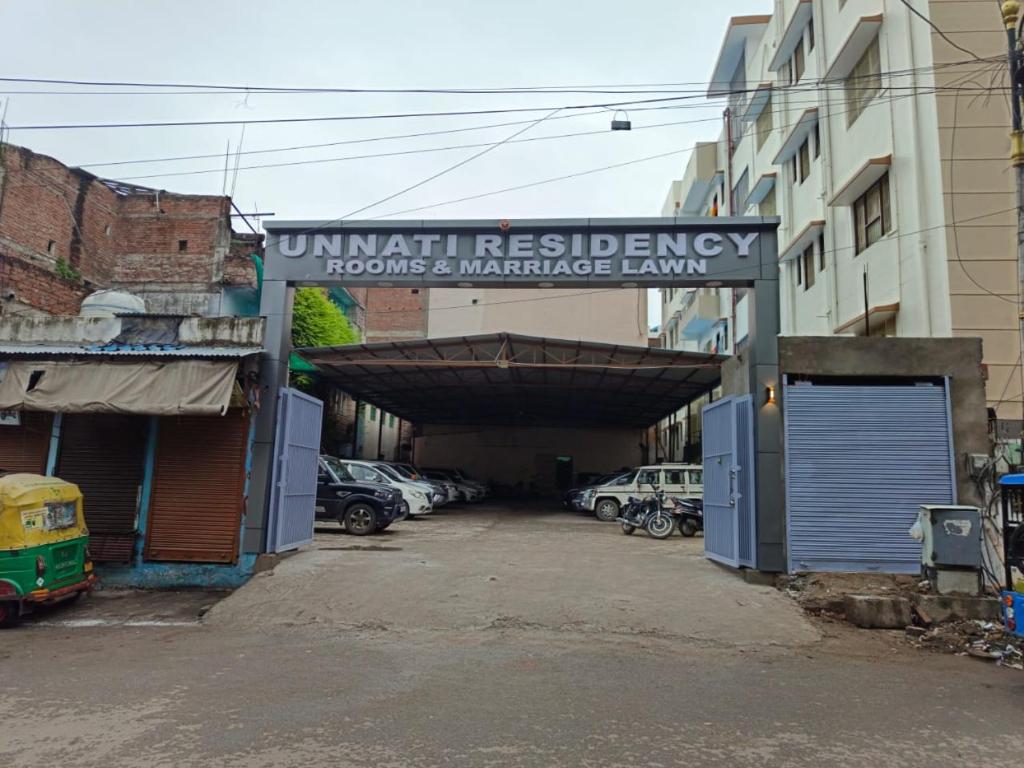 an entrance to a parking lot with cars parked at Unnati Residency in Varanasi