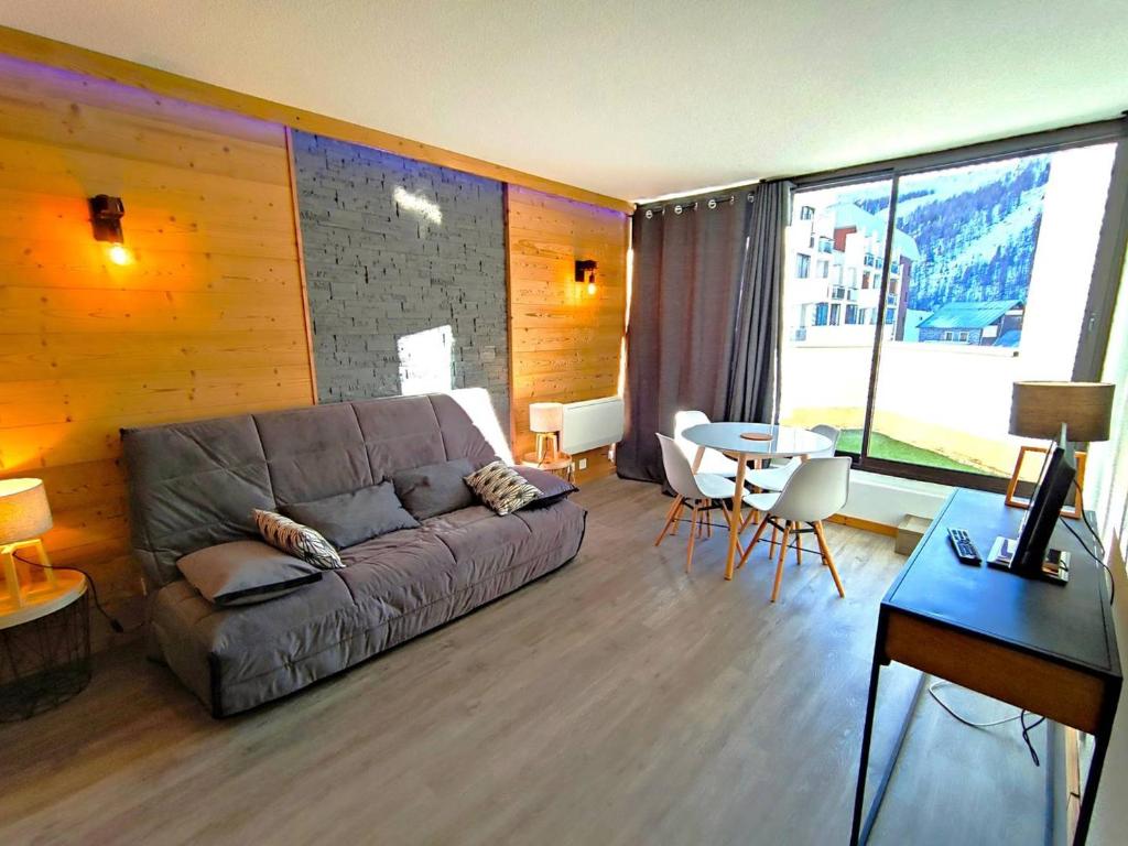 a living room with a couch and a table at Appartement Rénové 2P avec Balcon Sud, Front de Neige, au Pied des Pistes - FR-1-292-64 in Isola 2000