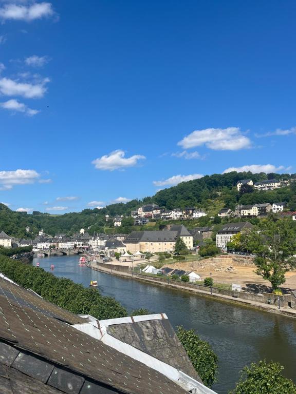 una vista de un río con una ciudad en el fondo en Le refuge du Cerf, en Bouillon
