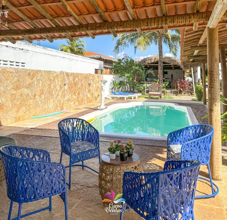 a patio with chairs and a swimming pool at Pousada Recanto dos Ventos in Icaraí