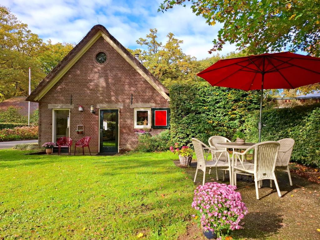 a table and chairs with an umbrella in a yard at Spijkvoorde in Deventer