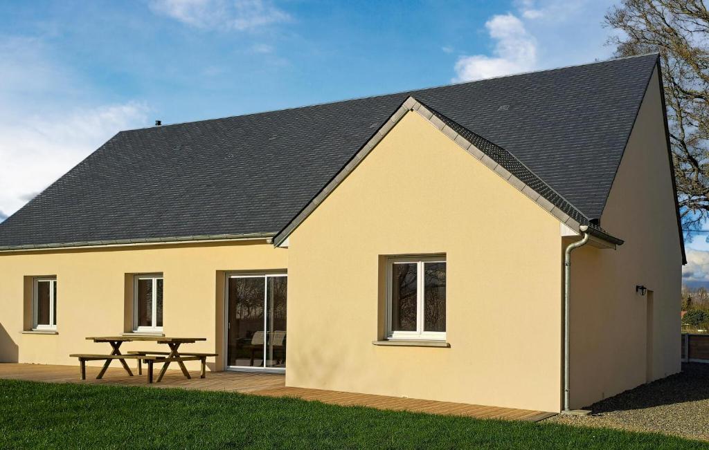 a large yellow house with a picnic table at Awesome Home In Bacilly With Wifi in Bacilly