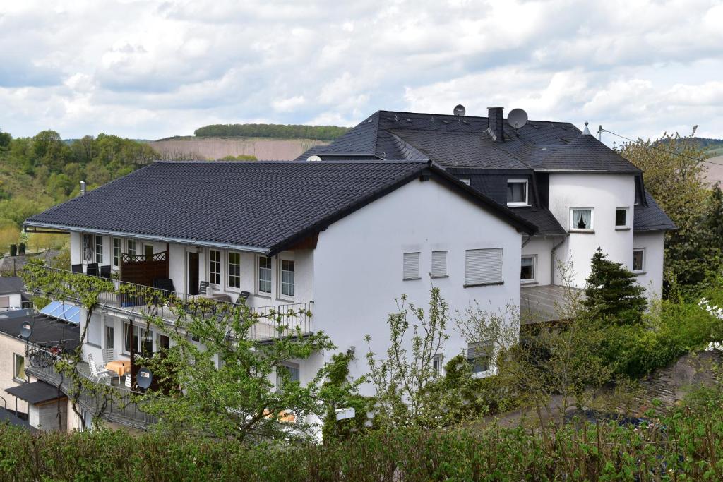 a white house with a black roof at Ferienweingut Borens in Wiltingen
