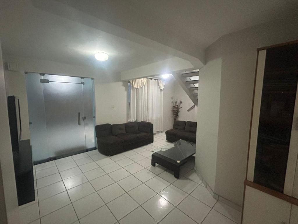 a living room with two couches and a couch at Casa Confortável in Belém