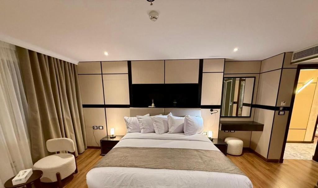 a hotel room with a large bed and a mirror at SWAN DAHABIYA Luxury Boutique Nile Cruise - Every Friday from Aswan for 3 nights & Every Monday from Luxor for 4 nights in Luxor