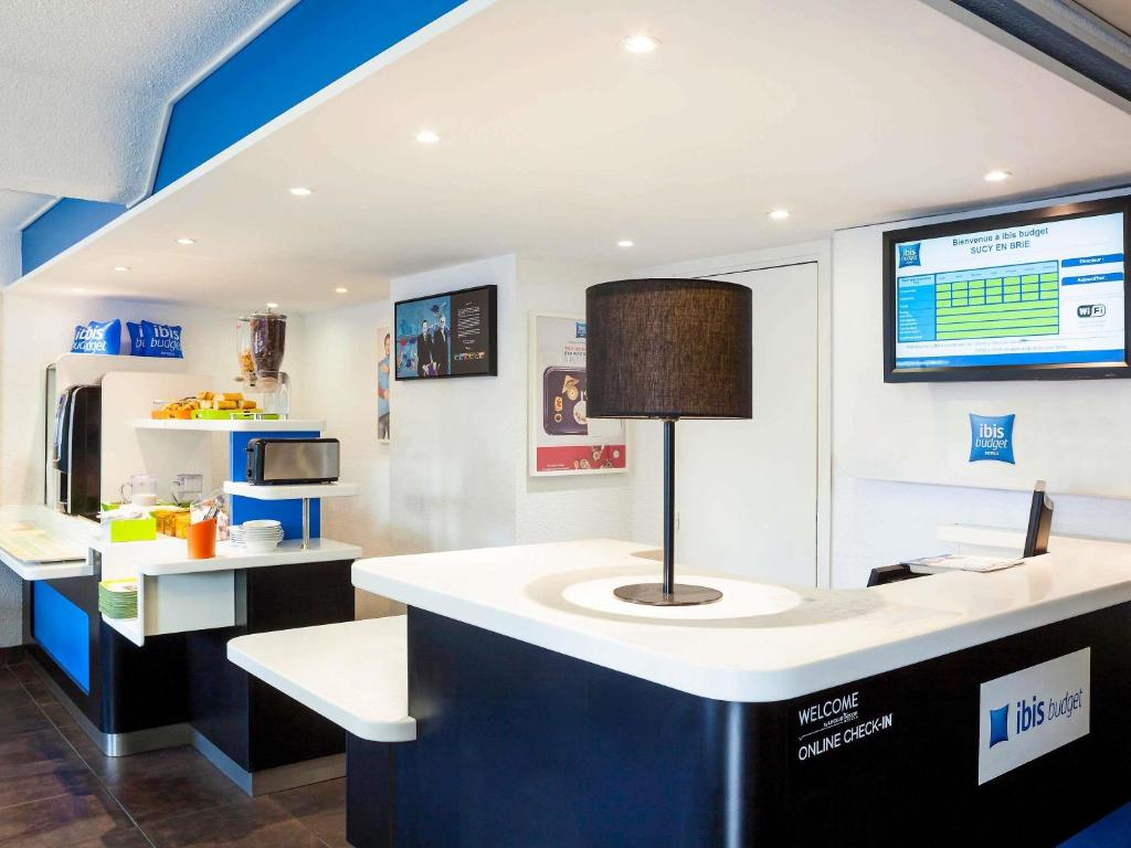 a kitchen with a counter with a lamp on it at Ibis Budget Sucy en Brie in Sucy-en-Brie