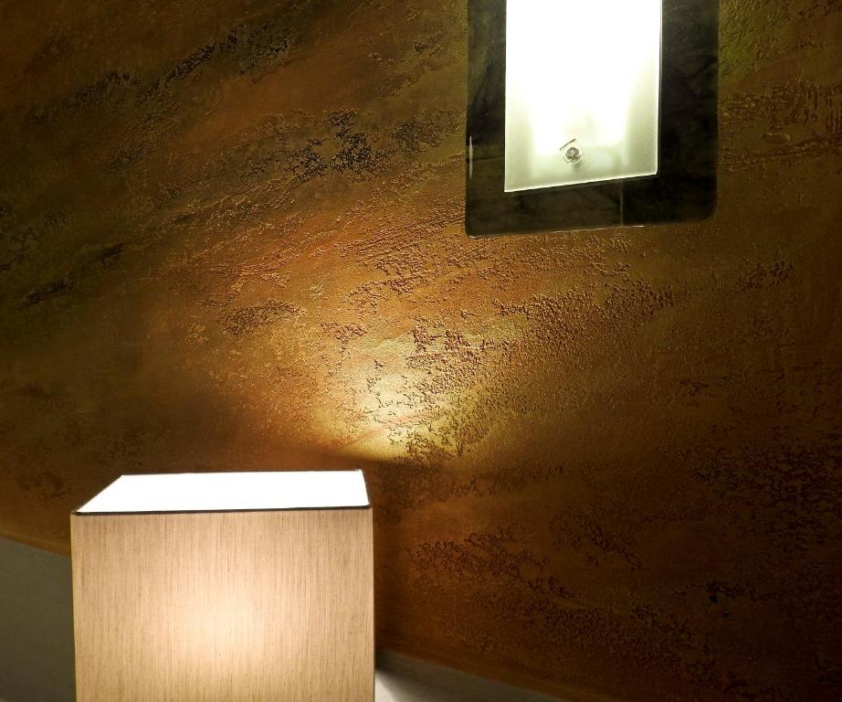 a light on a wall next to a wooden box at Albergo Annabella in Santa Margherita Ligure