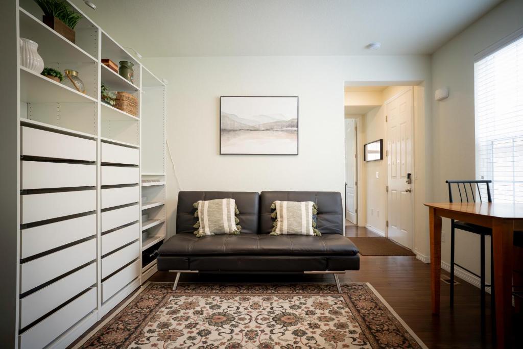 een zwarte leren bank in een woonkamer met een tafel bij Stylish Retreat in Parker Near Hwy, Parks & Dining in Parker