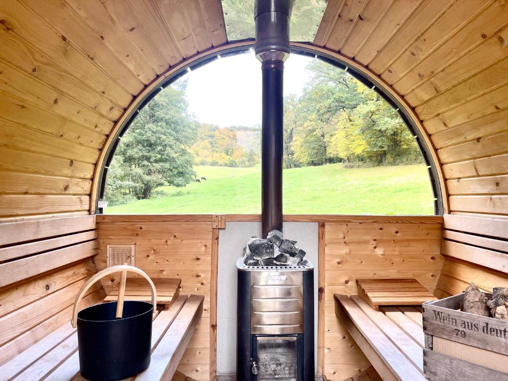 an inside view of a wooden cabin with a large window at Tiny Ferienhaus 2 am Rimbach in Steinau an der Strasse in Steinau an der Straße