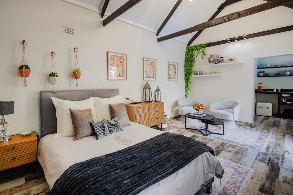 a bedroom with a bed and a desk and a chair at The Pillans Manor Studio in Cape Town