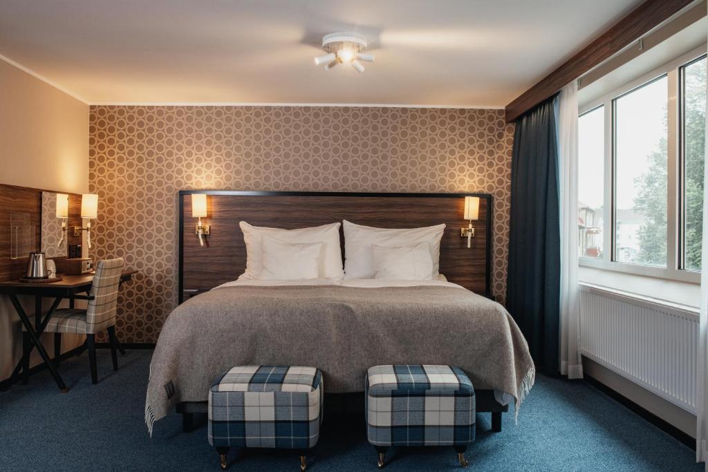 Giường trong phòng chung tại Home Hotel Slottsparken