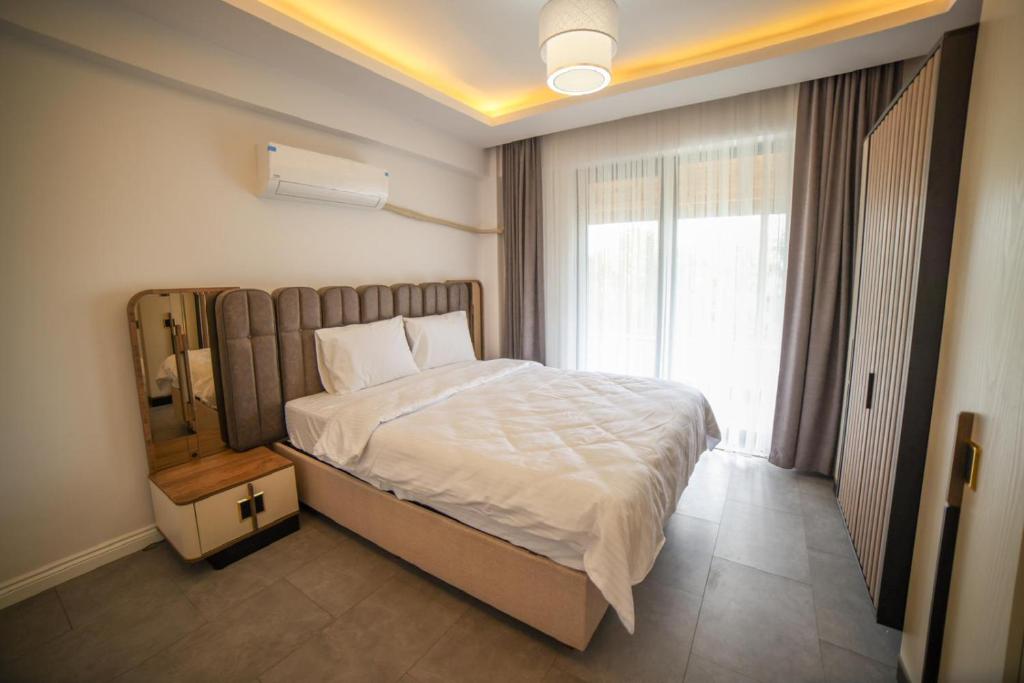 a bedroom with a large bed and a window at Asil Villas in Sapanca